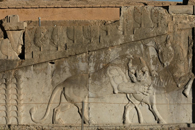 the relief on the wall depicts a man riding a horse