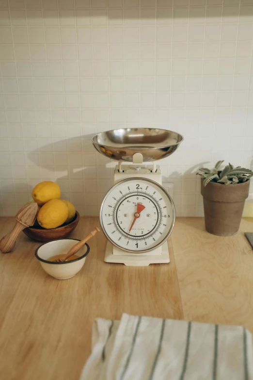 an old fashion scale with food and fruit on top