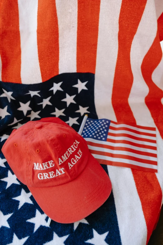 an american flag and hat with some writing on it