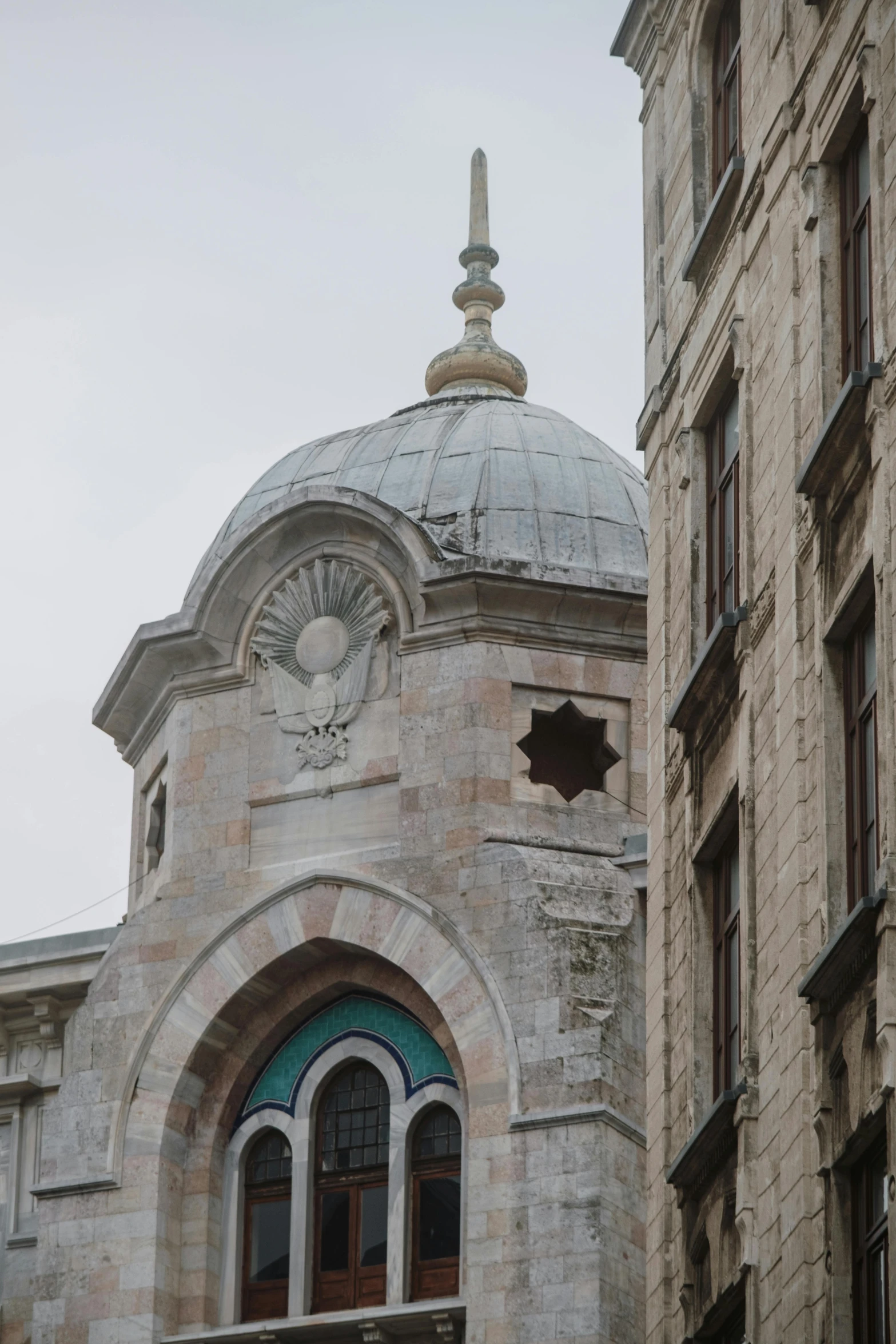 a large building with an intricate dome with a cross window on the front of it