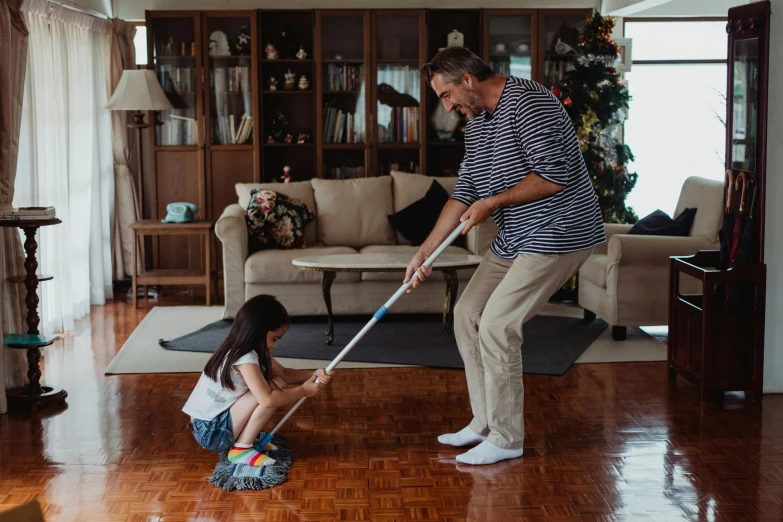 a woman and a girl are cleaning the floor