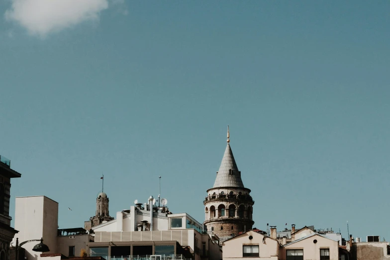 a tall building with a spire on top is shown against a blue sky