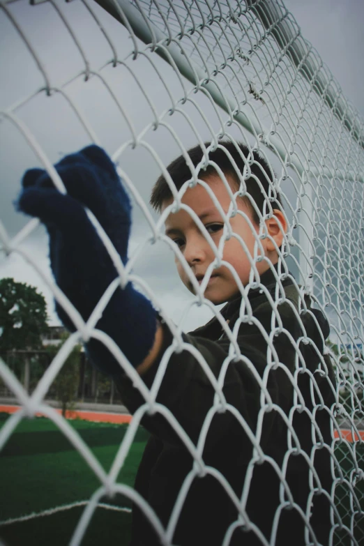 there is a boy standing in the net