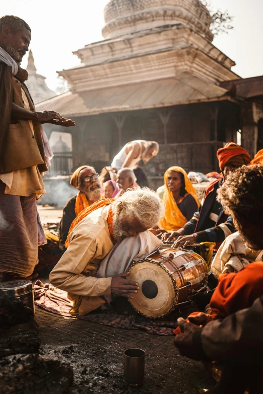 a group of people gathered around playing and singing together