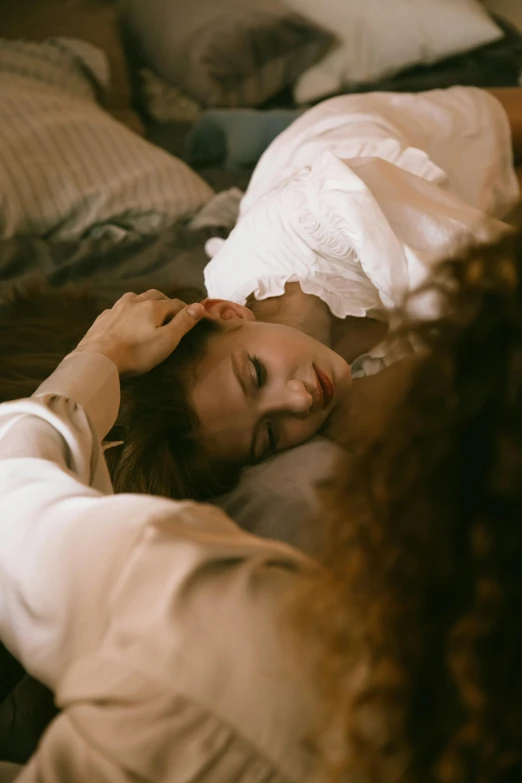 a young woman in white dress laying on a bed