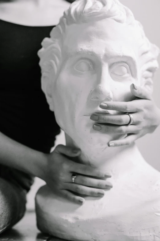 woman with ring around her neck waxing statue