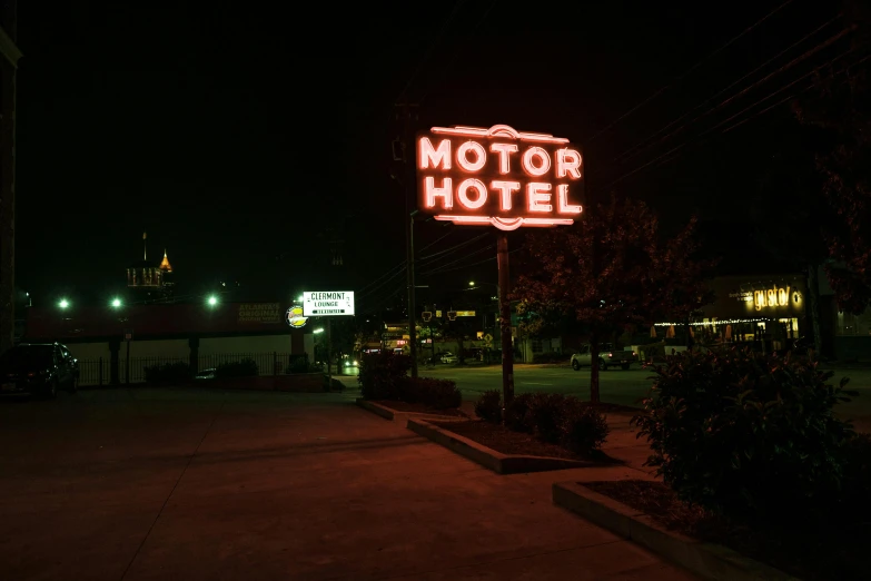 a neon sign that reads motor el is illuminated