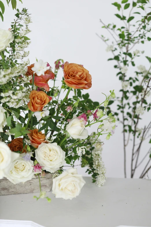 flowers in a vase are shown near other greenery