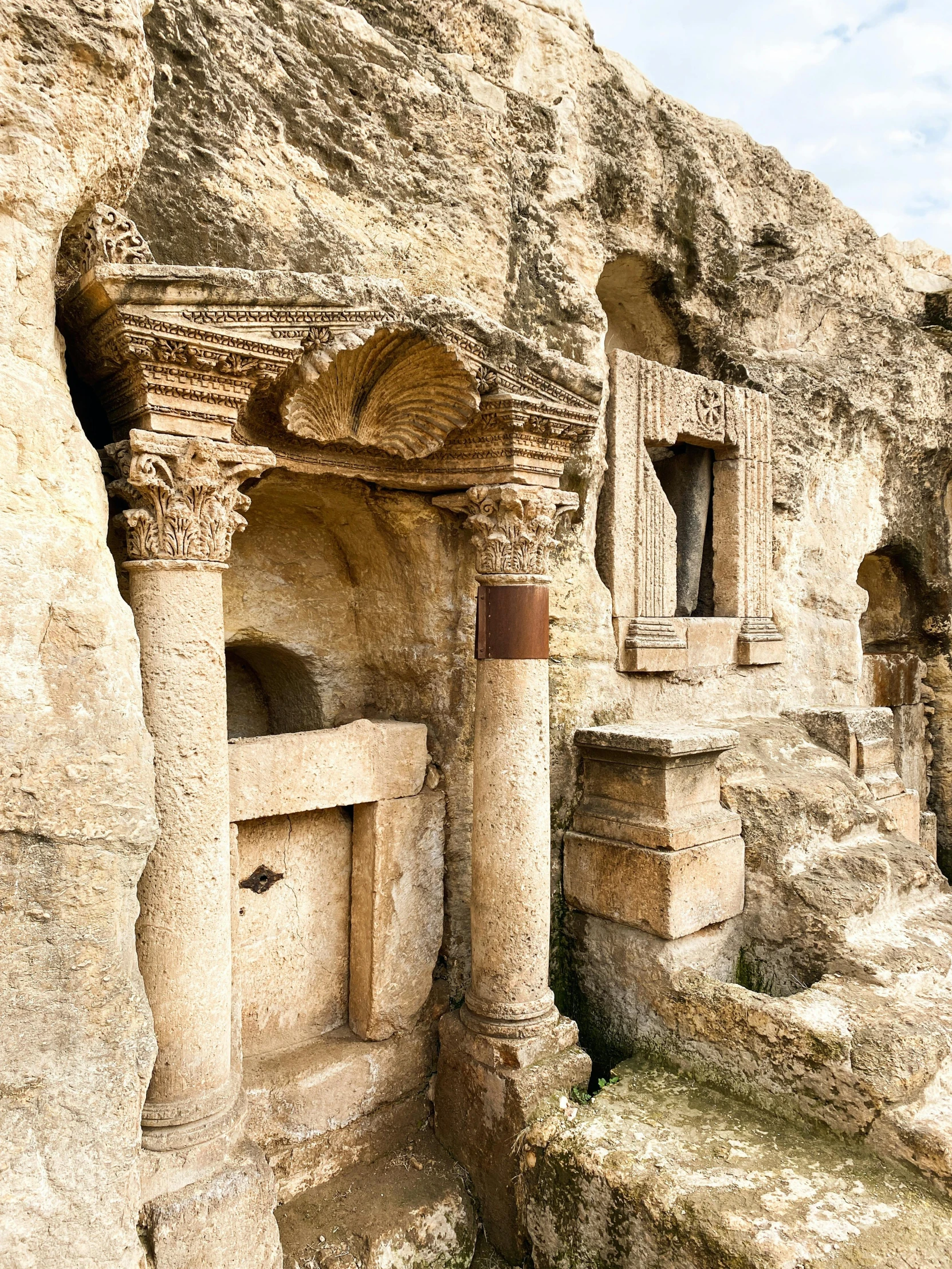 a rock - cut out structure with several small doorways inside of it