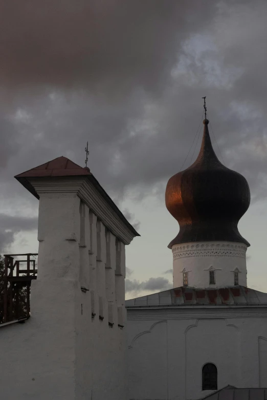 a church with a pointed roof on a cloudy day