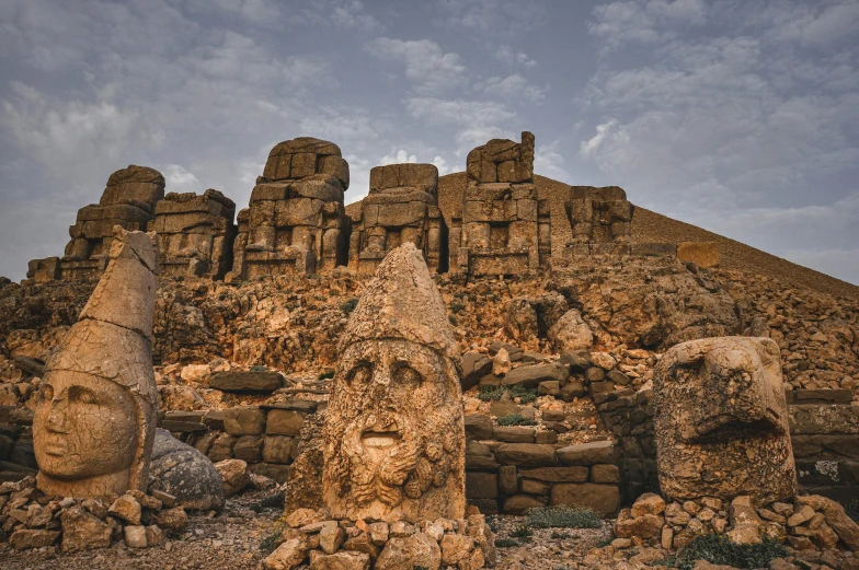 the ruins are made from stones and have faces on them