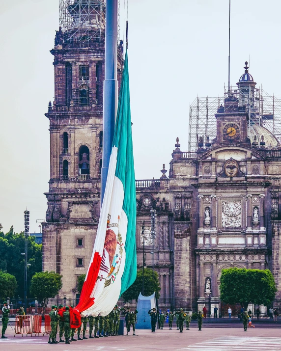 the old clock tower and flags in front of a castle