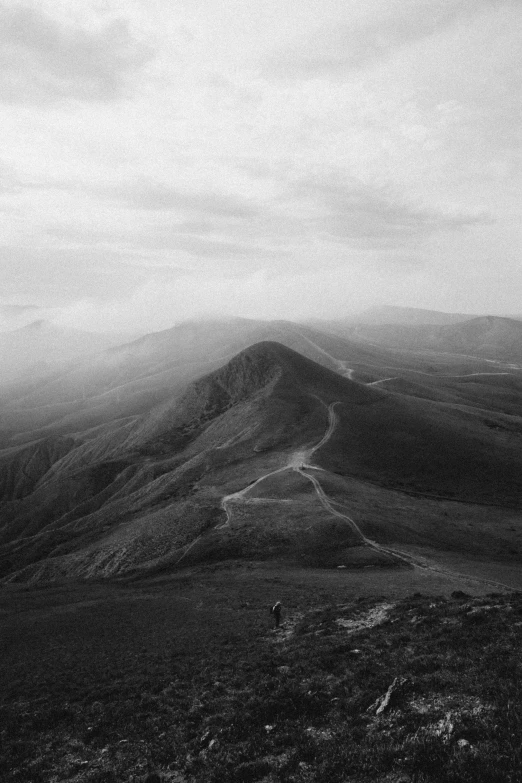 a cloudy mountain top with some clouds in the background