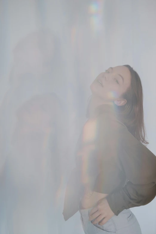 woman wearing dark clothing standing in white light