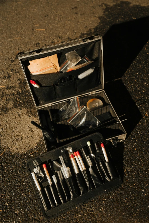 a silver case filled with different types of pens