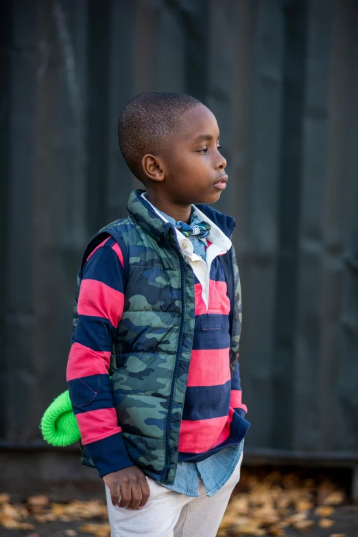 a  is standing outside on a fall day