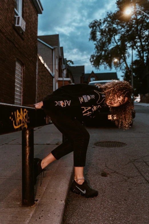 woman in a wet suit leans on a rail