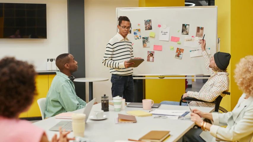 people in a classroom setting, with a man speaking