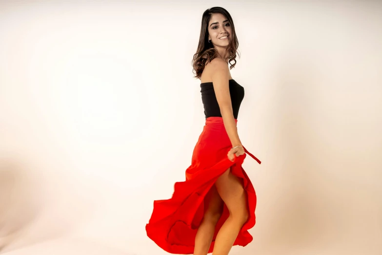 a beautiful young woman wearing a red skirt