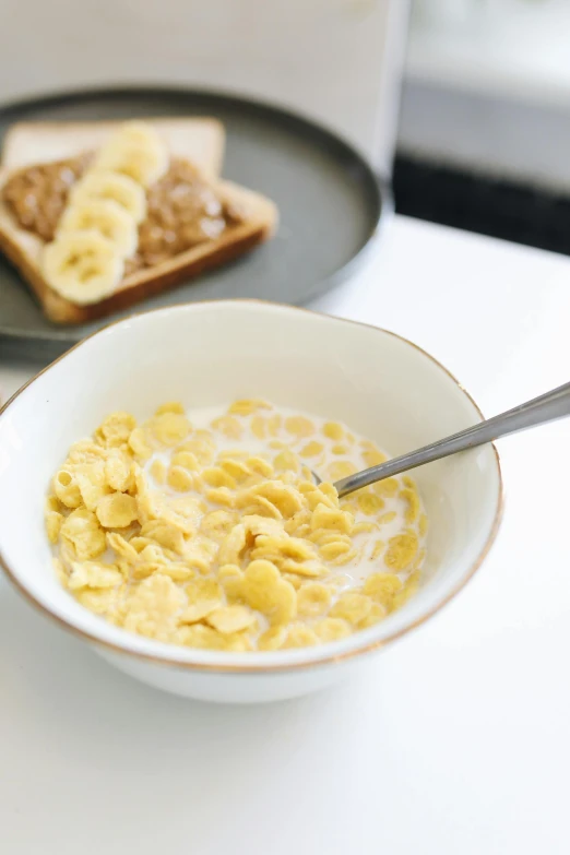 a bowl of cereal with toast on the side