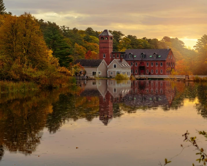 a house on a body of water surrounded by trees