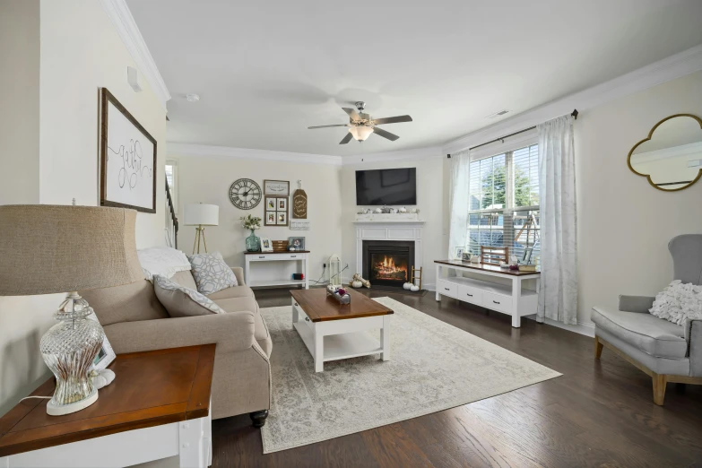 a room with white furniture, an orange chair and a brown coffee table