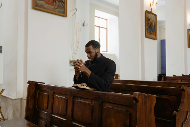 a man is praying in the sanctuary of an old church