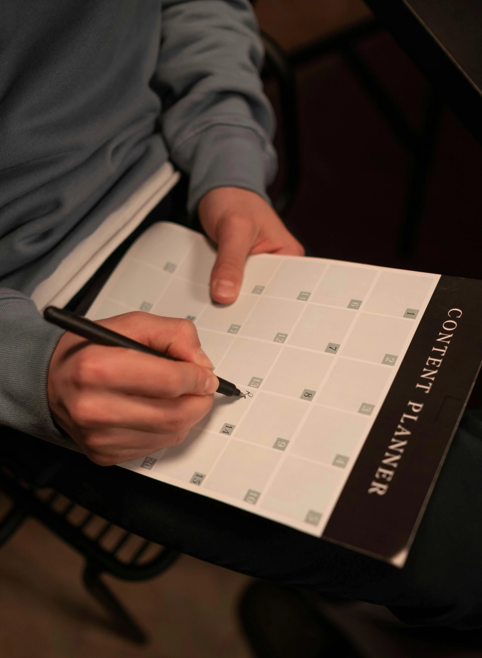 a person writing on a piece of paper