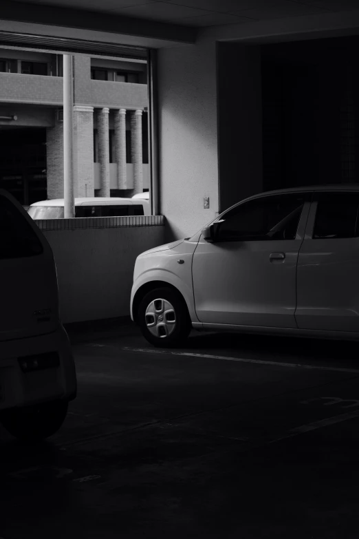 two cars parked next to each other in a building