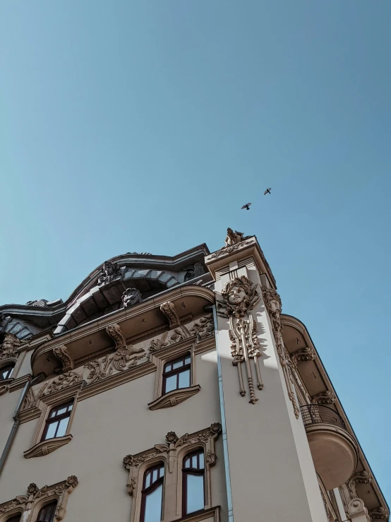 a large, three story building with many windows and a clock on it