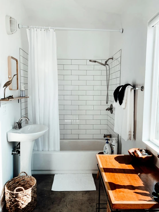 an old bathroom that is white and has a sink, tub and shower