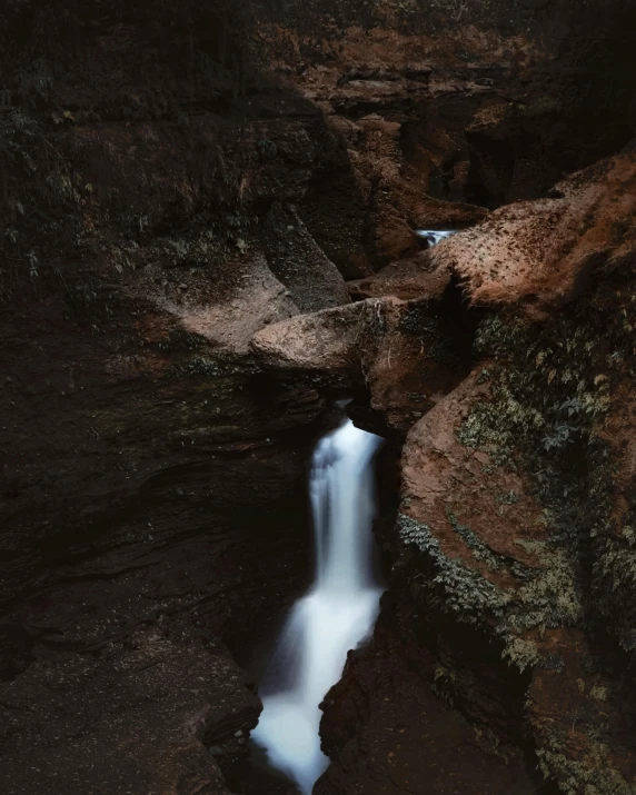 a waterfall cascading down into a rocky creek