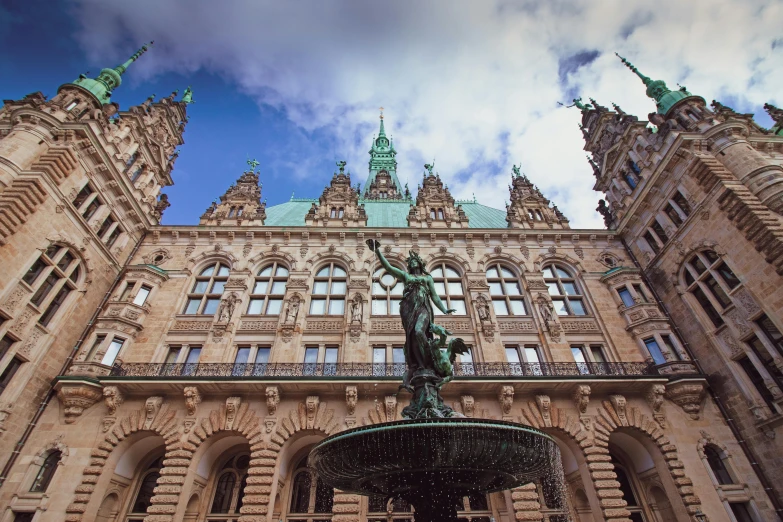 the large building has statues on it's sides