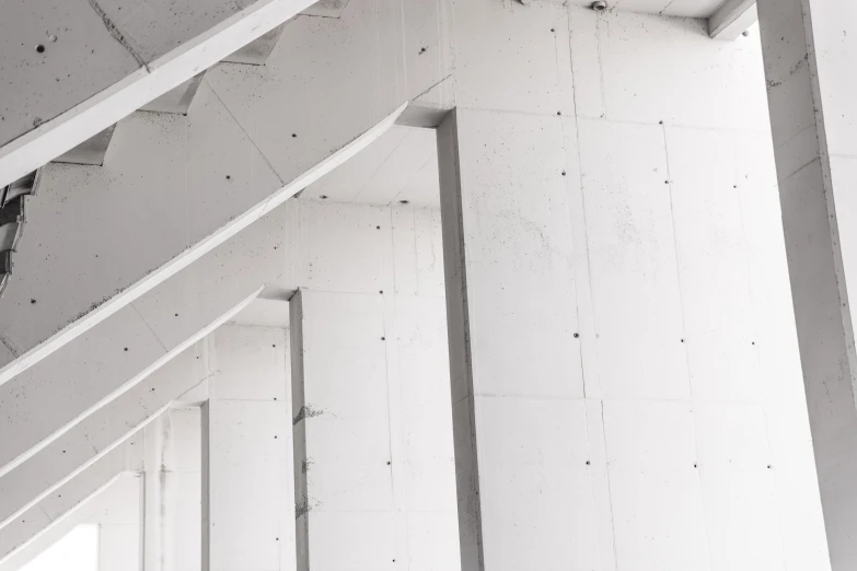 a building with exposed concrete and a light hanging from the ceiling