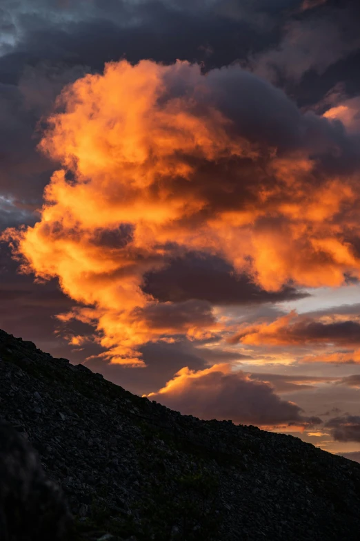 the sunset in the sky over a hill with a horse silhouette