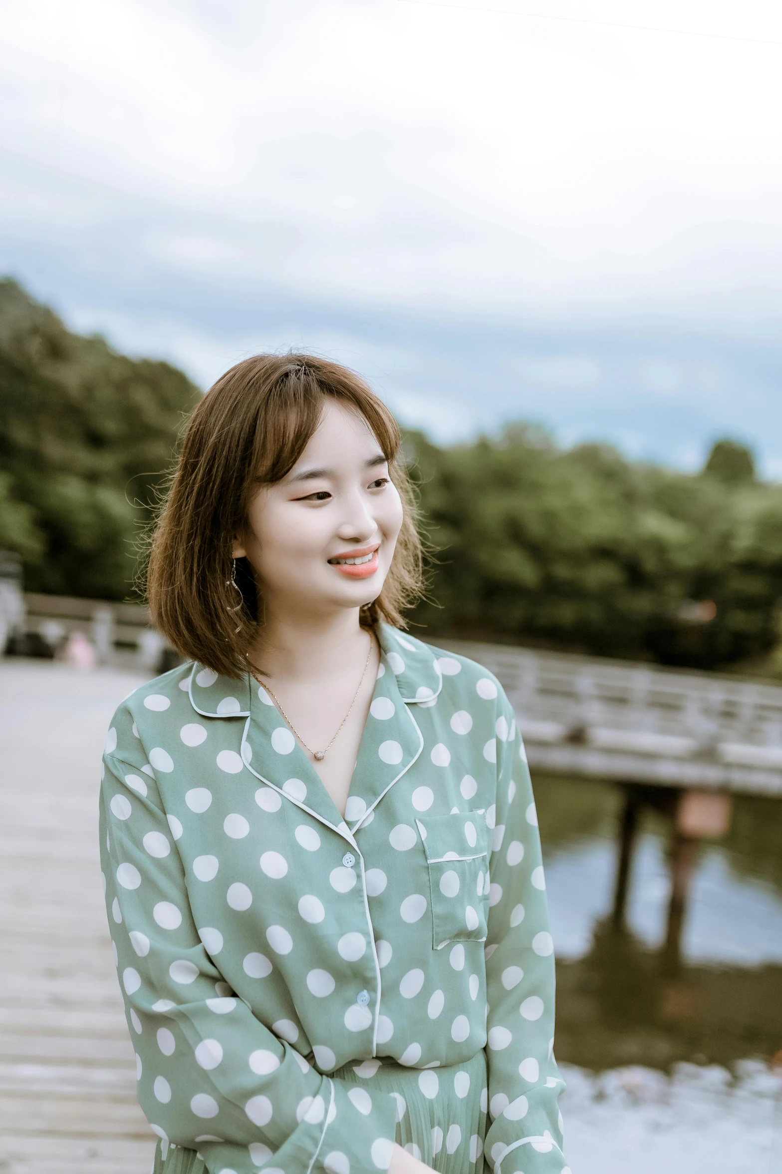 a girl in a polka dot shirt smiles for the camera