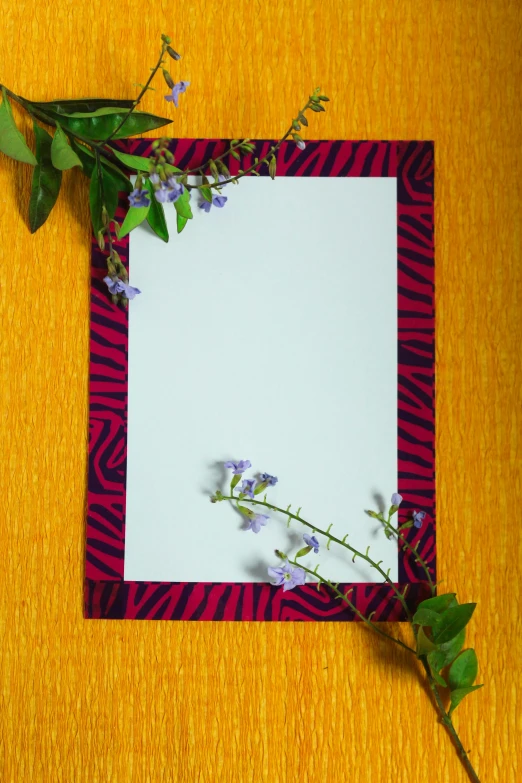 a square piece of paper with purple flowers