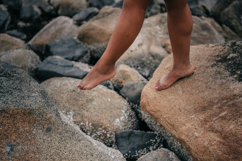 a person standing on top of large rocks