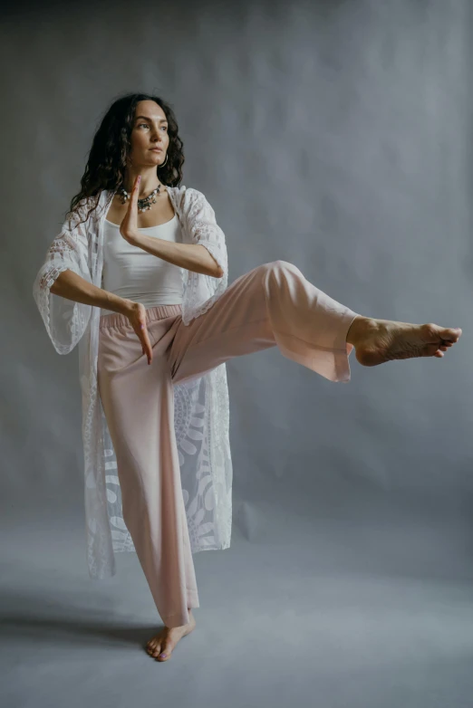 an attractive woman poses in a po studio