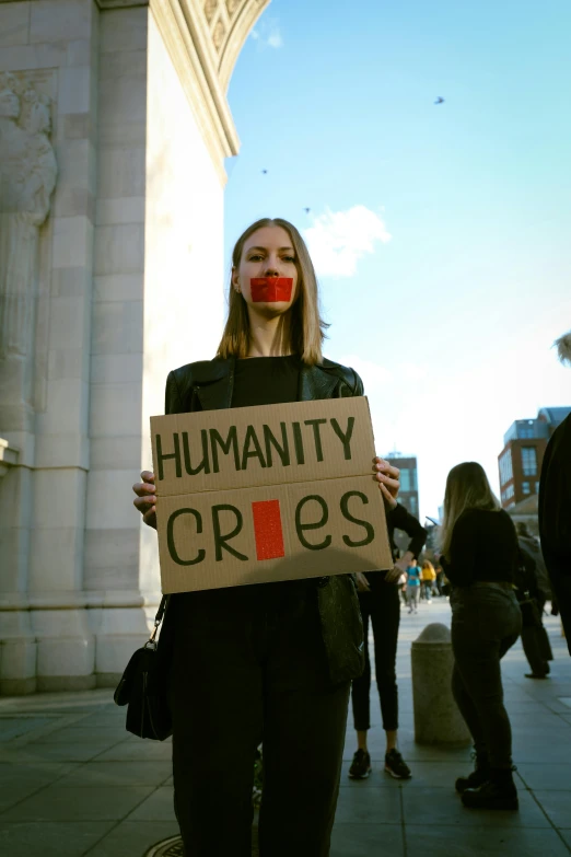 a person that is standing up holding a sign