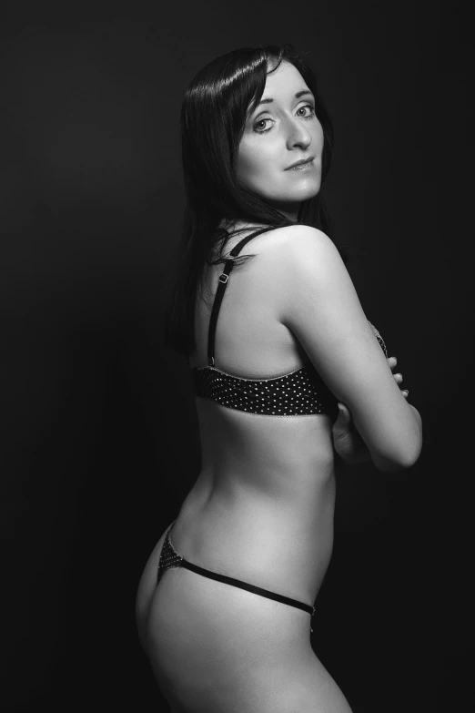 a woman wearing lingerie and smiling for a po