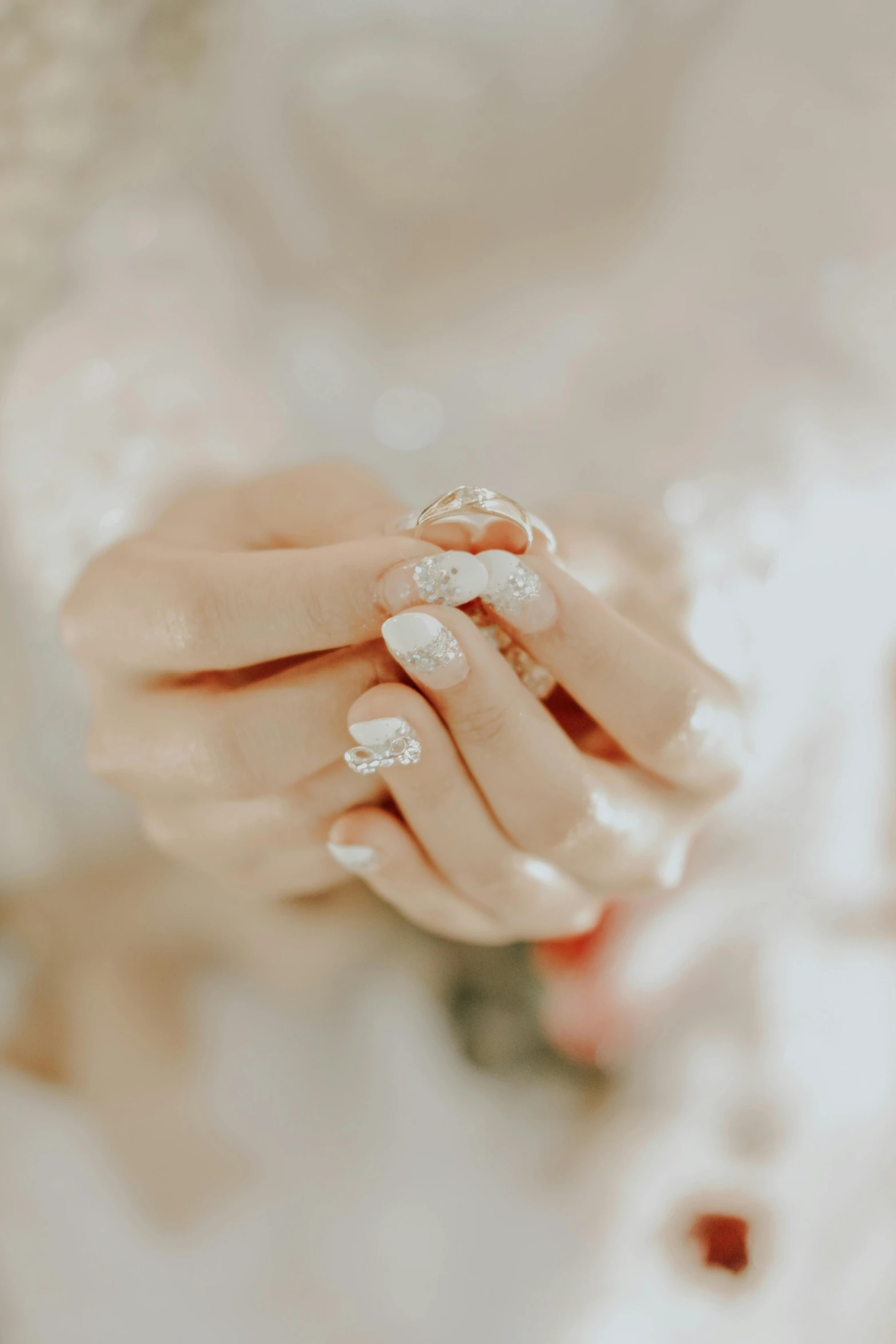 an elegant wedding dress with a manicured wedding ring