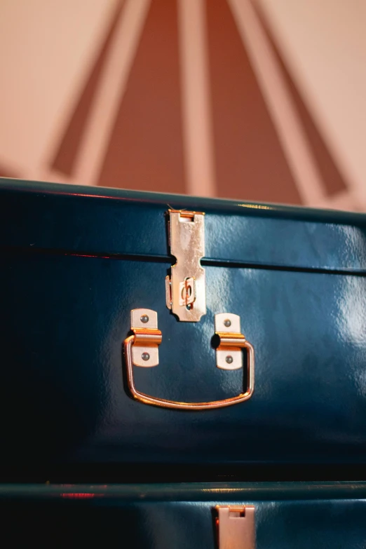 two empty and one brown suitcase sitting on the floor