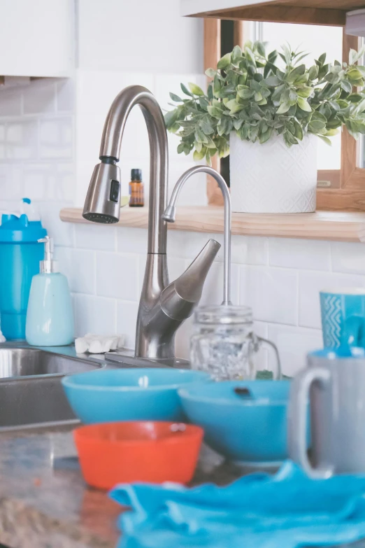 a kitchen with dishes in the sink and a sink faucet