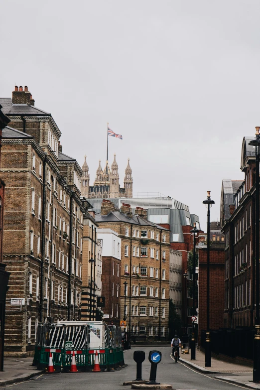 several buildings lining a street with a sky background