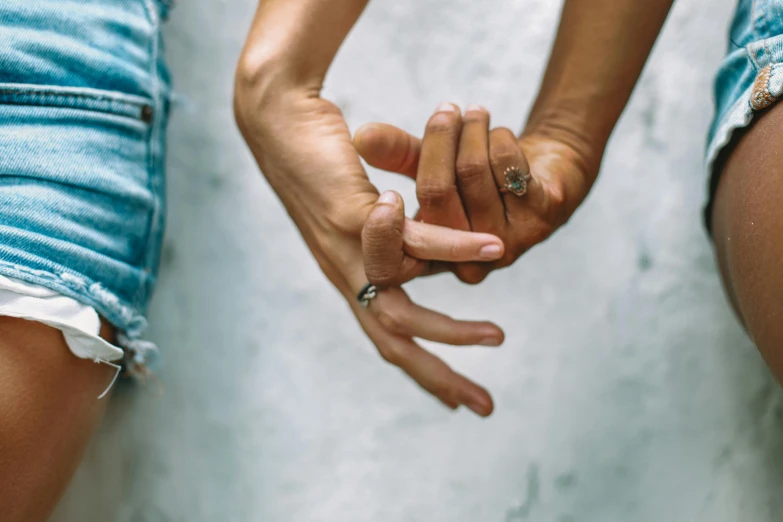 two people hold hands and look at the camera