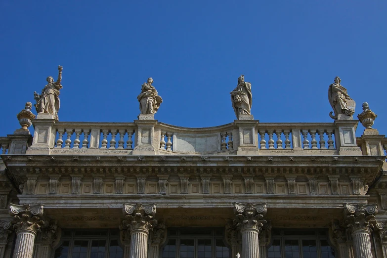 the front of an old building with statues on it
