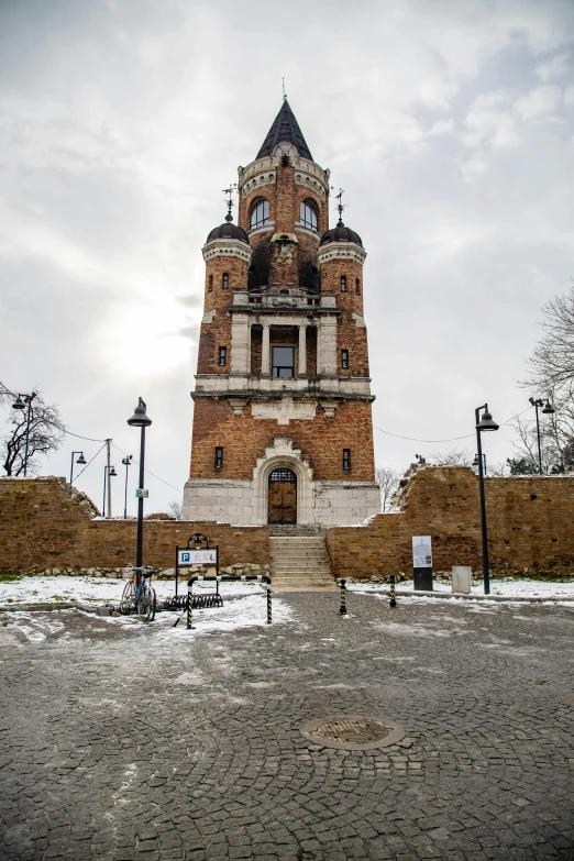 a clock tower sitting on top of a cement field