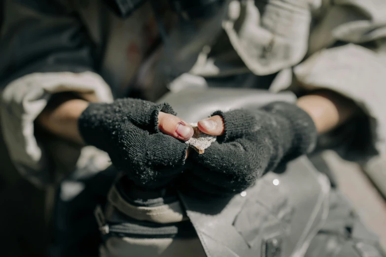 an individual wearing winter wear has their hand out on the glove