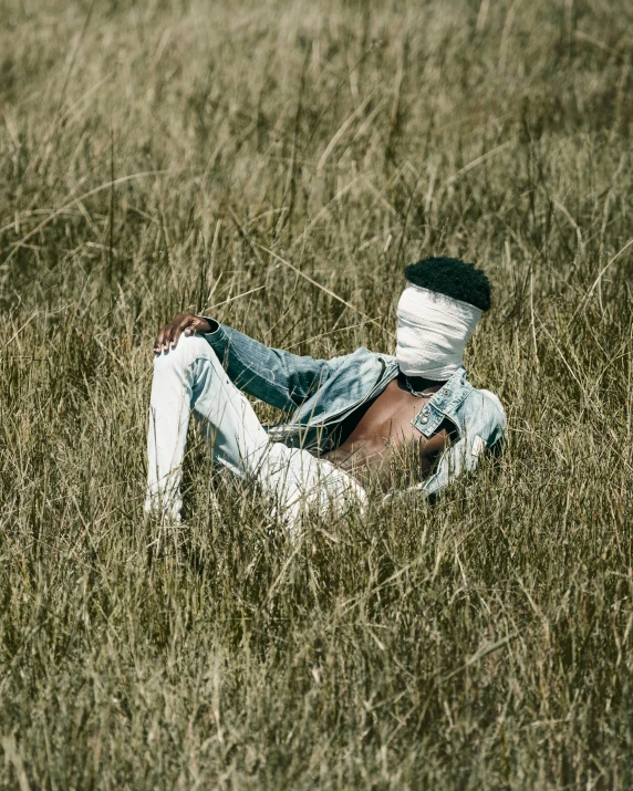 a boy has fallen asleep in the grass